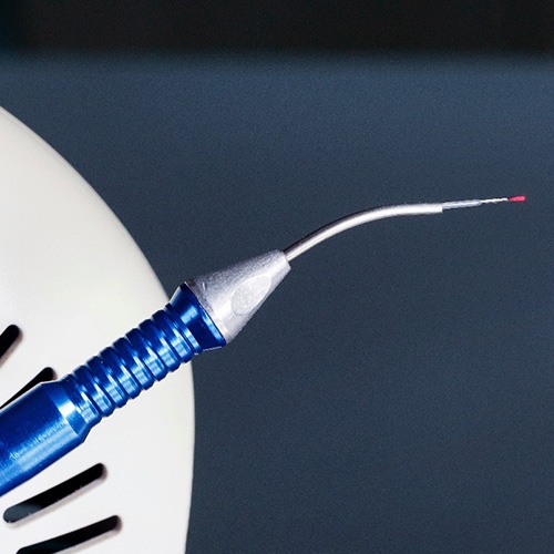 Close-up of dental laser device against neutral background