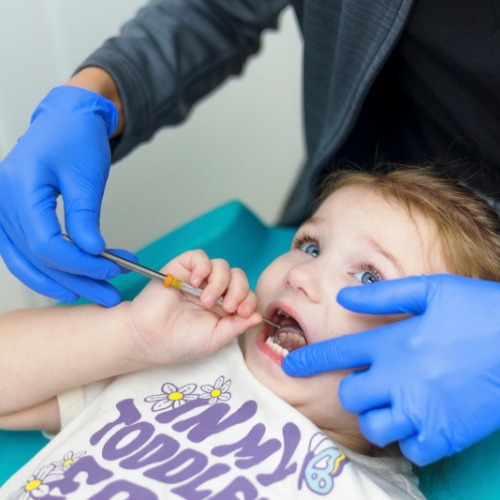 Young girl grinning at her dentist