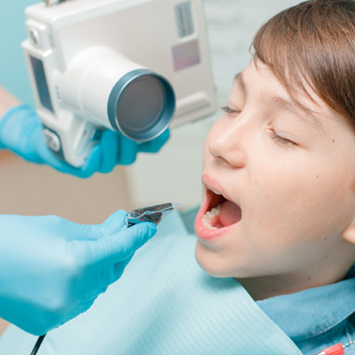 Young boy having dental X-ray taken 