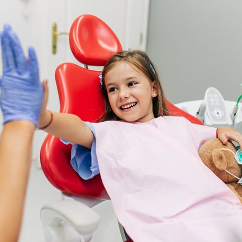 Cute kid high-fives dentist