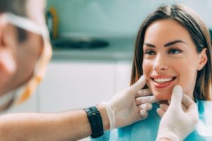 Young woman getting smile examined by dentist.