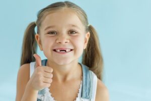 Child with missing front teeth.
